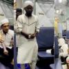 Video Shows Group Praying in Train Aisle as Man Holds Bat-Like Object