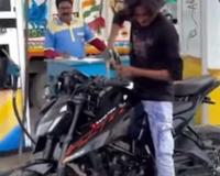 Man Washes Bike with Petrol at Fuel Station, Viral Video Sparks Outrage Over Waste and Safety Risks
