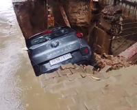 Heavy Rain Triggers Road Collapse in Ghaziabad, Car and Scooter Plunge into Deep Pit