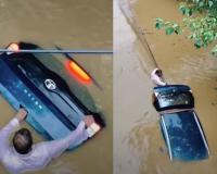 Man Clings to Submerged Tata Nexon EV During Flood, Video Shows Emotional Bond With Vehicle