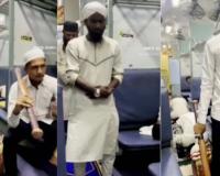 Video Shows Group Praying in Train Aisle as Man Holds Bat-Like Object